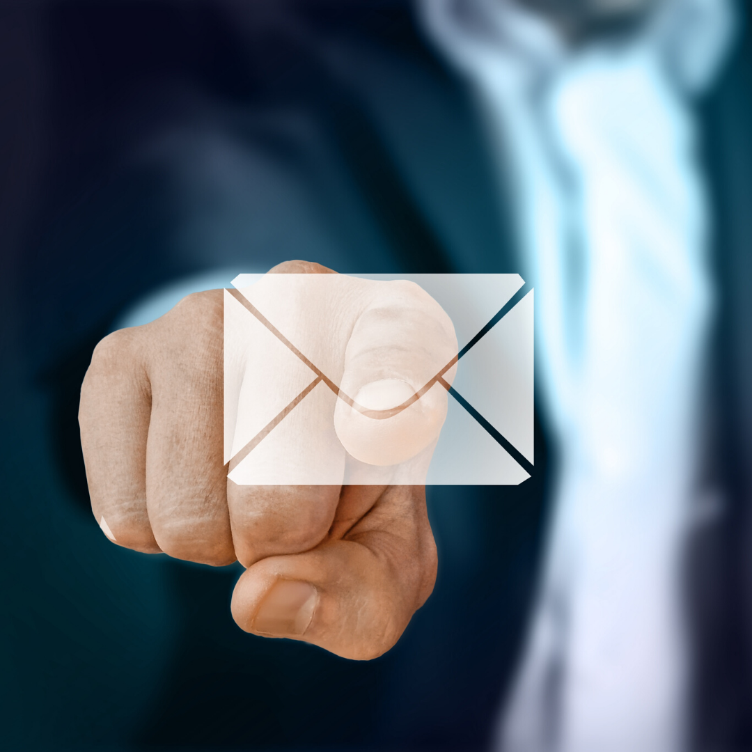 Email Marketing | a man in a dark suit pointing his finger at an email envelope